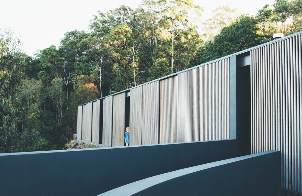 a timber and glass pavilion that opens to the Noosa hinterland and ocean beyond